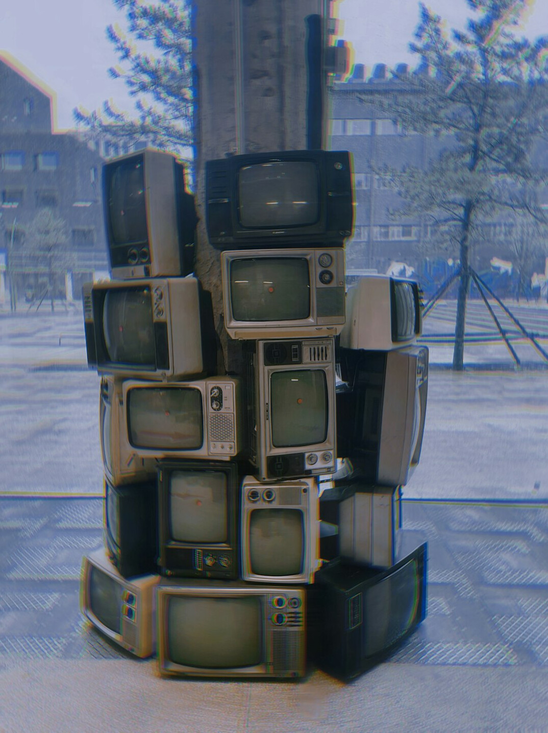 Stack of glowing vintage CRT television monitors