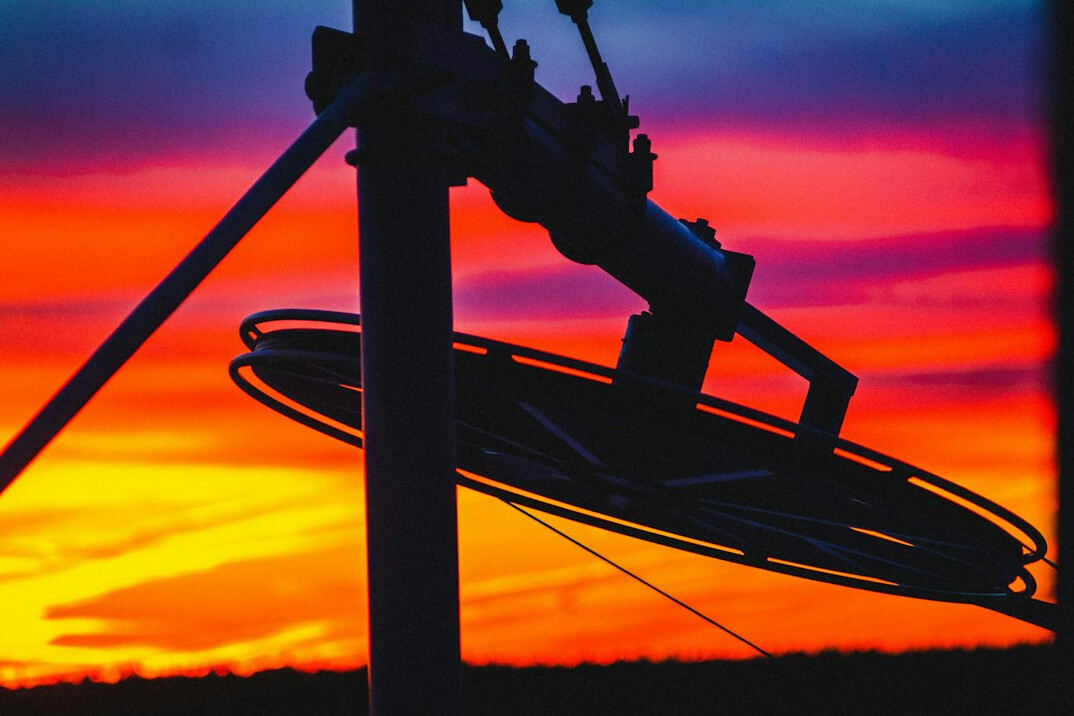 Large satellite dish against a dusk sky for broadcast transmission